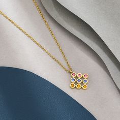 Style is personified with this festive design. An amazing amalgamation of natural navaratna gemstones and 18K gold, this 18K Gold pendant will adorn your graceful neck with true poise and charm. Elegant Multicolor 22k Gold Necklaces, Multicolor 22k Gold Necklace For Gift, Multicolor 22k Gold Necklace Gift, 22k Gold Multi-stone Multicolor Jewelry, Multicolor Multi-stone 22k Gold Jewelry, Multicolor 22k Gold Necklaces For Celebration, Multicolor Fusion Necklace For Gift, Multicolor Fusion Necklaces For Gifts, Multicolor Pendant Necklace In Fine Jewelry Style