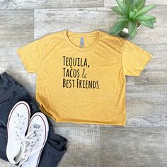 For sizing information, please see the size chart photo.Tequila, Tacos, & Best FriendsThese shirts are so soft and comfortable! Materials: 65/35 polyester/combed ring-spun cotton.This is a Moonlight Makers original design and all our shirts are screen printed by hand in our Asheville, NC Studio. Average time between placing your order and us shipping it out: 1 business day! Contact us for bulk custom and wholesale inquiries. Yellow Crew Neck Top With Funny Text, Yellow Casual Tops With Funny Text, Casual Yellow Tops With Funny Text, Yellow Casual Top With Funny Text, Asheville Nc, Asheville, Crop Tee, Tequila, Heather Gray