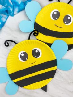 two paper plates that have been made to look like bees