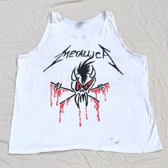 Vintage 1994 Metallica Tour Shirt Size XL. One sided. Condition ---  This shirt is in thrashed, stained vintage condition. Fading and overall wear. Lots of faint staining, marks and small holes. Measurements --- Pit to pit: 23 Inches Collar to bottom: 28 Inches Size: XL Tag: Anvil XL 100% Cotton   Color: White Please Read Before Buying: All measurements are made when the shirt is lying flat. Please always consider the measurements before buying any item. The listed tag size may not be the size o White Band Merch Tops For Alternative Fashion, White Grunge Tops For Music Festivals, Alternative White Band Logo Tops, Alternative White Band Logo Top, White Alternative Band Logo Top, Graffiti Print Top For Halloween Concert, Alternative White Tops With Band Logo, Graffiti Print Tops For Halloween Concert, White Alternative Top With Band Logo