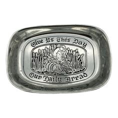 a metal tray with the words our daily bread on it and an image of jesus