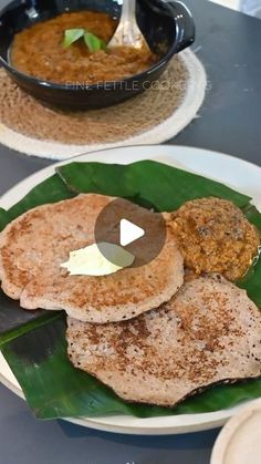 two plates with food on them sitting on a table