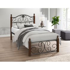 a bed with metal frame and headboard in a room