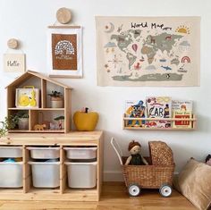 a child's playroom with toys, bookshelves and pictures on the wall