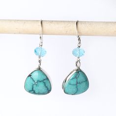 "These handmade earrings are of natural turquoise hand carved trillion cabochons bezel set in sterling silver. Above the turquoise is a bright blue faceted apatite bead. The earrings have a drop length of 1 1/2\" inch. Handmade in the USA. Dimensions: Each side of the triangle is 16mm. The apatite are 6mm. Drop length of 1 1/2\" inch. ❤️ Visit my shop: https://www.etsy.com/shop/JanPalomboDesign ❤️Click link below to see more earring designs: https://www.etsy.com/shop/JanPalomboDesign?section_id= Turquoise Faceted Drop Earrings, Turquoise Teardrop Faceted Earrings, Turquoise Faceted Teardrop Earrings, Turquoise Teardrop Faceted Jewelry, Faceted Turquoise Teardrop Earrings, Earring Designs, Silver Stacking Rings, Smokey Quartz, Natural Turquoise