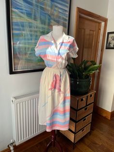 A totally gorgeous vintage summer dress in perfect pastels and white. Classic in shape and bold in design this piece feels timeless and contemporary--throw it on with white trainers, chunky sandals, kitten heels, or boots. You could style this so many ways from cocktails to beach cover up. Marked as a UK size 14, but as it's vintage it will be more like a modern 12--please do check the measurements in the photos. In excellent vintage condition, ready to be worn and loved again!  All items listed in Attic 1 Shop are vintage and pre-owned/pre-worn unless explicitly stated in the listing. Please be aware that this means items are not in brand new condition and you must read item descriptions thoroughly to ensure you are happy with the item before purchasing. Vintage clothing may not be labell Retro V-neck Midi Dress For Summer, Vintage V-neck Dress For Summer Daywear, Beach Summer Midi-length Shirt Dress, Beach Summer Midi Length Shirt Dress, Summer Midi-length Beach Shirt Dress, Summer Beach Midi Shirt Dress, Summer Midi Length Shirt Dress For Beach, Daytime Midi Length Summer Shirt Dress, Chic Vintage Midi Dress For Summer