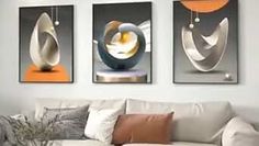 three abstract paintings hang on the wall above a white couch in a modern living room