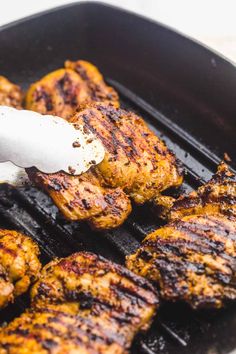 the meat is being grilled on the grill with a spatula in it's mouth