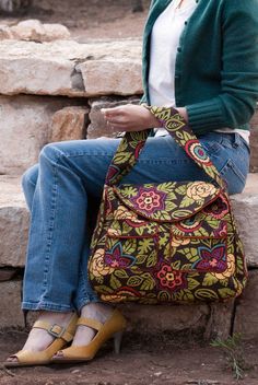 a woman is sitting on the steps with her purse