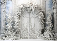 an ornate white door surrounded by snow covered trees