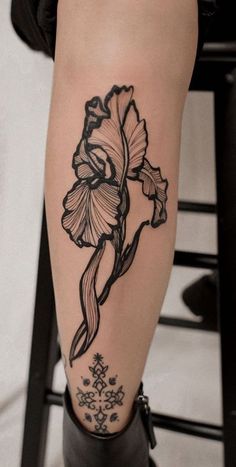 a woman's leg with a flower tattoo on it