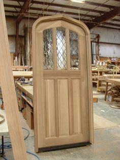 a large wooden door sitting inside of a building