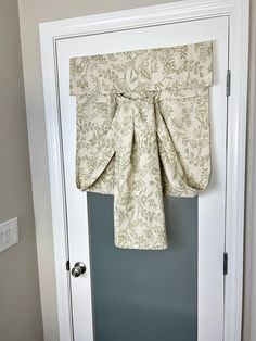 an open door with a curtain hanging from it's side