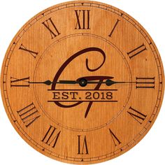 a wooden clock with roman numerals and the date on it's face