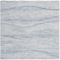 a white and blue rug with wavy lines