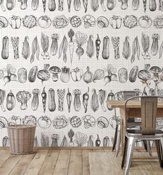 the wallpaper in this dining room is drawn with black and white ink