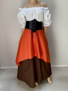 a mannequin is dressed in an orange and brown dress with black trims