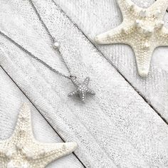 Dive into whimsical elegance with our Starfish Hidden Pearl Necklace—a playful yet refined masterpiece that captures the enchanting splendor of the starfish. This exquisite necklace unveils a hidden pearl within the intricacies of the starfish design, adding a touch of mystery to its charm. Whether worn for a special occasion or to elevate your everyday style, this piece is a testament to seaside allure. Bring the magic of the ocean to your ensemble and showcase your love for marine-inspired sop Elegant Starfish Charm Jewelry As Gift, Elegant Starfish Charm Jewelry Gift, Elegant Starfish Charm Jewelry For Gifts, Starfish-shaped Necklace With Pearl Charm For Gift, Elegant Starfish Necklace For Gift, Elegant Starfish Charm Necklace For Beach, Elegant Starfish Charm Pendant Jewelry, Elegant Pendant With Starfish Charm, Elegant Starfish Charm Star Necklace