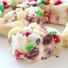 a close up of a slice of cake with candy and m & ms on it