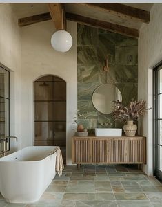 a bath room with a tub a sink and a large mirror on the wall above it