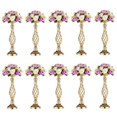 twelve gold vases with purple and white flowers on each one, all arranged in the same row