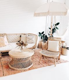 a living room with wicker furniture and an umbrella