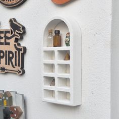 there is a sign on the wall that says bee spirit and some bottles in it