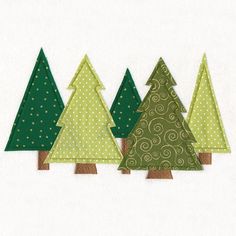 three small christmas trees in green and brown