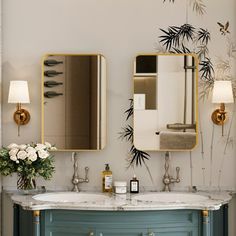 a bathroom with two sinks and mirrors on the wall