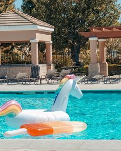 an inflatable unicorn float floats through the pool