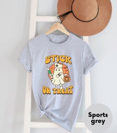 a t - shirt that says stick or treat on it next to a straw hat