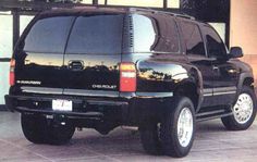 a black suv parked in front of a building