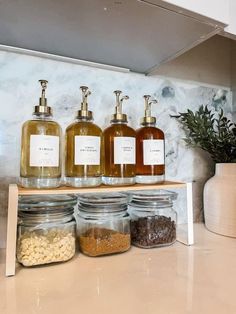 jars filled with different types of soap and lotion on top of a kitchen counter