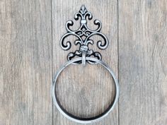 an ornate metal ring on a wooden surface