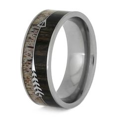 a wedding ring with an arrow in the center and antelope wood inlay