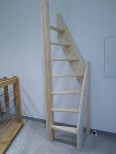 a wooden staircase next to a glass case