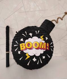 a black bomb with boom written on it next to a pen and paper mache