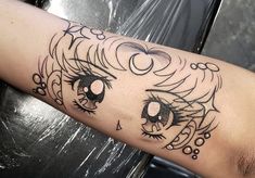 a woman's arm with a black and white tattoo design on her left arm