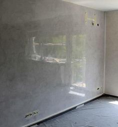 an empty room is being painted white and has no curtains on the windows or walls