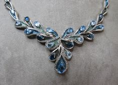 "From Macy's Fine Jewelry department, here's an exceptional sterling silver cocktail necklace set with teardrop shaped topaz stone in shades of blue. Each stone is mounted on an enameled leaf, and bordered by small diamonds. The entire piece measures 17\" in length, and is signed on the back and lobster claw clasp '925'. Thanks for looking." Blue Gem Necklace, Cocktail Necklace, Filigree Pendant Necklace, Silver Diamond Necklace, Crescent Necklace, Silver Cocktail, Big Diamond, Filigree Pendant, Blue Gems