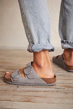 **Fit:** Narrow: A-B Width Classic two-strap style Birkenstock featuring large statement buckles and a distressed look. Genuine leather straps are featured with comfortable, lightweight sole. * Anatomically shaped cork-latex footbed A Birkenstock narrow width fit is comparable to a Medium (B Width). | Arizona Big Buckle Birkenstock Sandals at Free People in Grey, Size: EU 36 Big Buckle Birkenstock, Birkenstock Arizona Big Buckle, Arizona Big Buckle, Birkenstock Outfit, Sandals Outfit, Birkenstock Sandals, Buckle Sandals, Birkenstock Arizona, Shoe Style