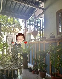 a woman sitting in a hammock with potted plants on the porch behind her