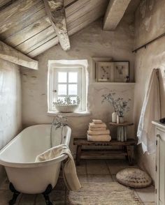 an old fashioned bathroom with a claw foot bathtub and rugs on the floor