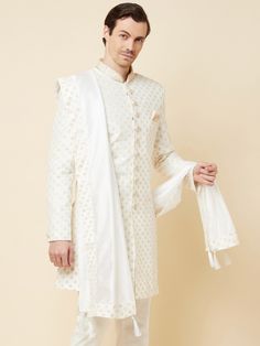 This Royal White Embroidered sherwani will instantly give an elegant look. Made from polyester cotton fabric, this 3 piece sherwani set features a white royal sherwani, front buttons fastening, designer cuff buttons, pocket square, and a mandarin collar. This white base sherwani has beautiful subtle gold Jaal thread-sequin embroidery work all over. It is paired with white churidar pants and matching dupatta. An ideal outfit for traditional & special events.

Size Chart For Men





	
	
					Men' Embroidered Off White Cotton Sherwani, Embroidered Off-white Cotton Sherwani, White Sherwani With Naqshi Embroidery, White Embroidered Straight Kurta Sherwani, White Straight Kurta Sherwani With Embroidery, White Cotton Nehru Jacket With Zari Work, White Embroidered Straight Sherwani, Cotton Nehru Jacket For Wedding With Traditional Drape, Wedding Nehru Jacket With Traditional Drape