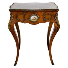 an antique wooden table with marble top