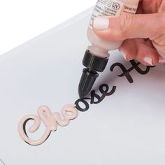 a person is writing on a piece of paper with marker and glue, next to the word stencil