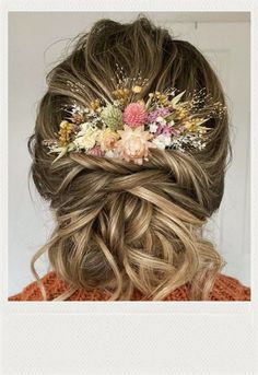 a woman with long hair and flowers in her hair is wearing a flowered headpiece