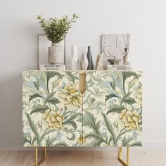 a sideboard with flowers painted on it next to vases and other decorative items