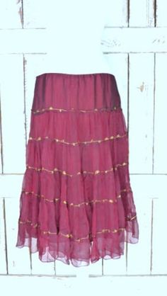 "Vintage sheer silk dark red ruffle midi skirt/mid length tiered festival skirt/90s burgundy/maroon silk skirt/large Features... -sheer 100% overlay -accented with metallic gold threading -stretch poly lining -midi length -zipper side -90's vintage Measurements...taken flat -marked size: large -across waist: 18\" -length: 29\" Condition... -excellent vintage condition -minimal wear UJ2065" Elegant Festive Ruffle Skirt, Festive Elegant Ruffled Skirt, Festive Ruffled Tiered Skirt Dresses, Festive Tiered Ruffled Skirt Dresses, Fall Tiered Ruffled Skirt, Elegant Tiered Summer Skirt, Bohemian Ruffled Skirt For Party, Flowy Full Skirt With Ruffles, Fitted Tiered Dress With Pleated Skirt