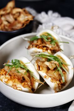 some food is sitting on a white plate and ready to be eaten with chopsticks